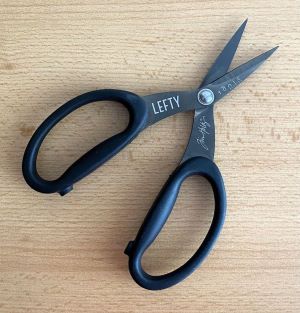 lefty scissors on wooden surface