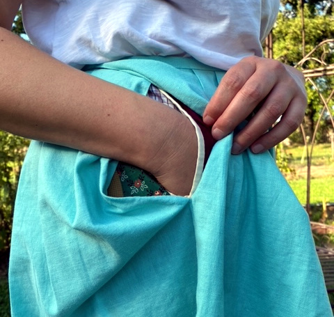 closeup of pocket under the skirt with hand inside